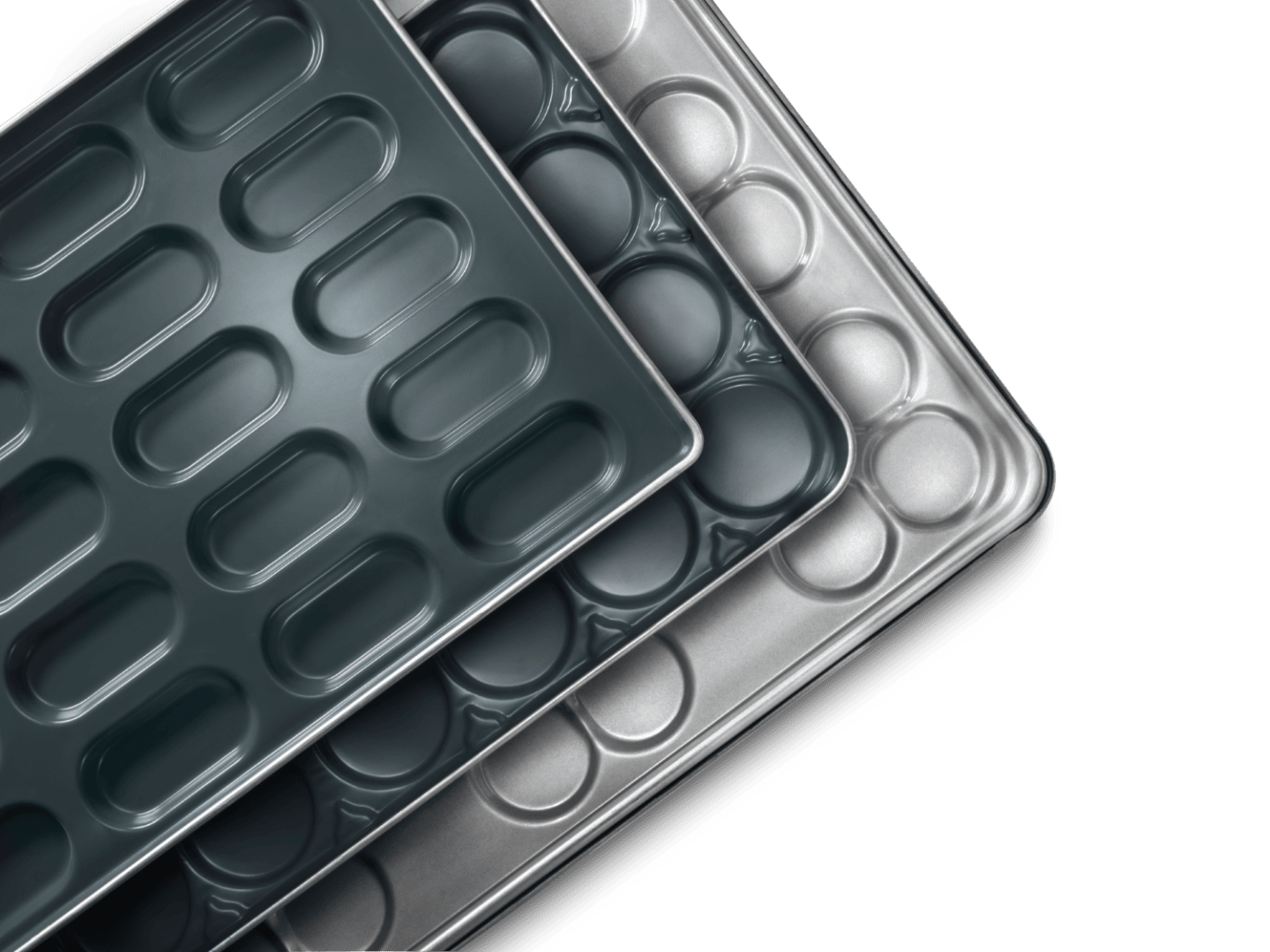 Three overlapping baking trays or pans with oval-shaped molds, shown from above on a black background. Each tray has a nonstick or metallic finish and features multiple rounded compartments.