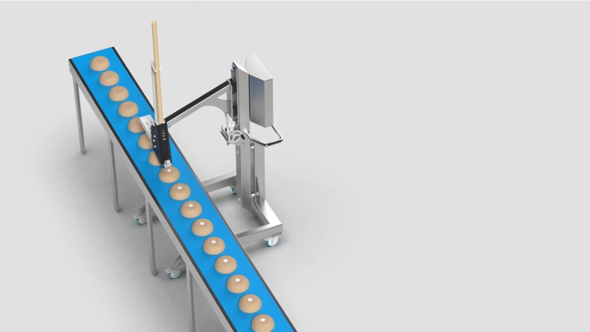 A blue conveyor belt with evenly spaced round buns moves past a machine holding a large knife, positioned to slice or cut the buns as they pass. The background is plain and white.