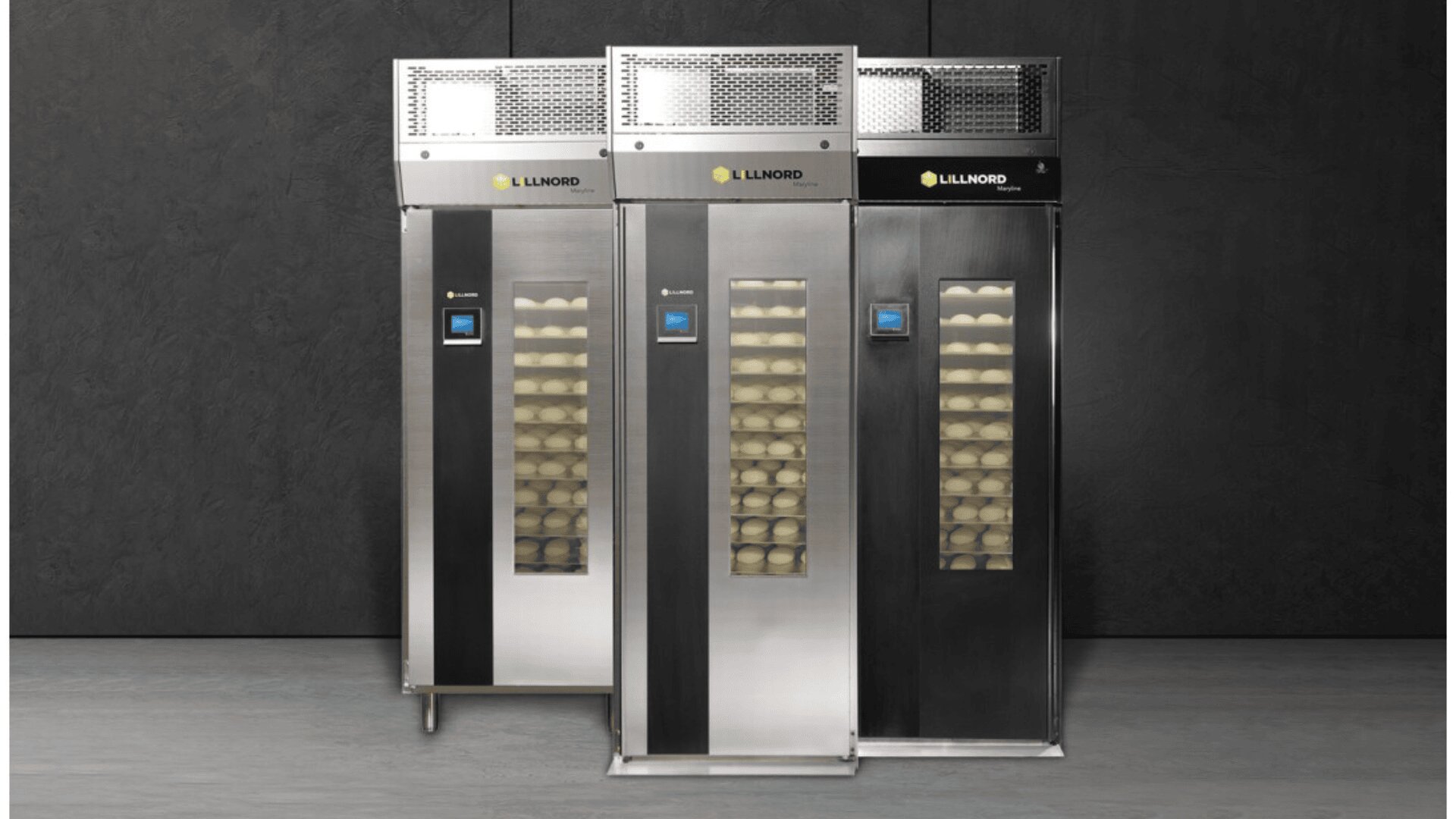 Three tall, stainless steel commercial bakery proofing cabinets with glass doors display trays of dough inside. The units have digital control panels and are labeled Lillnord at the top.
