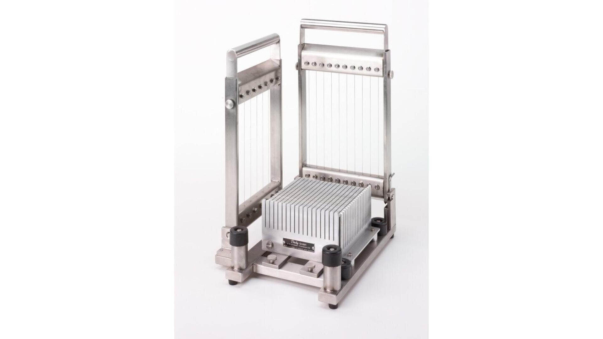 A metal tissue slicer with vertical wires and adjustable frame, used for evenly slicing biological tissue samples, is shown on a white background.