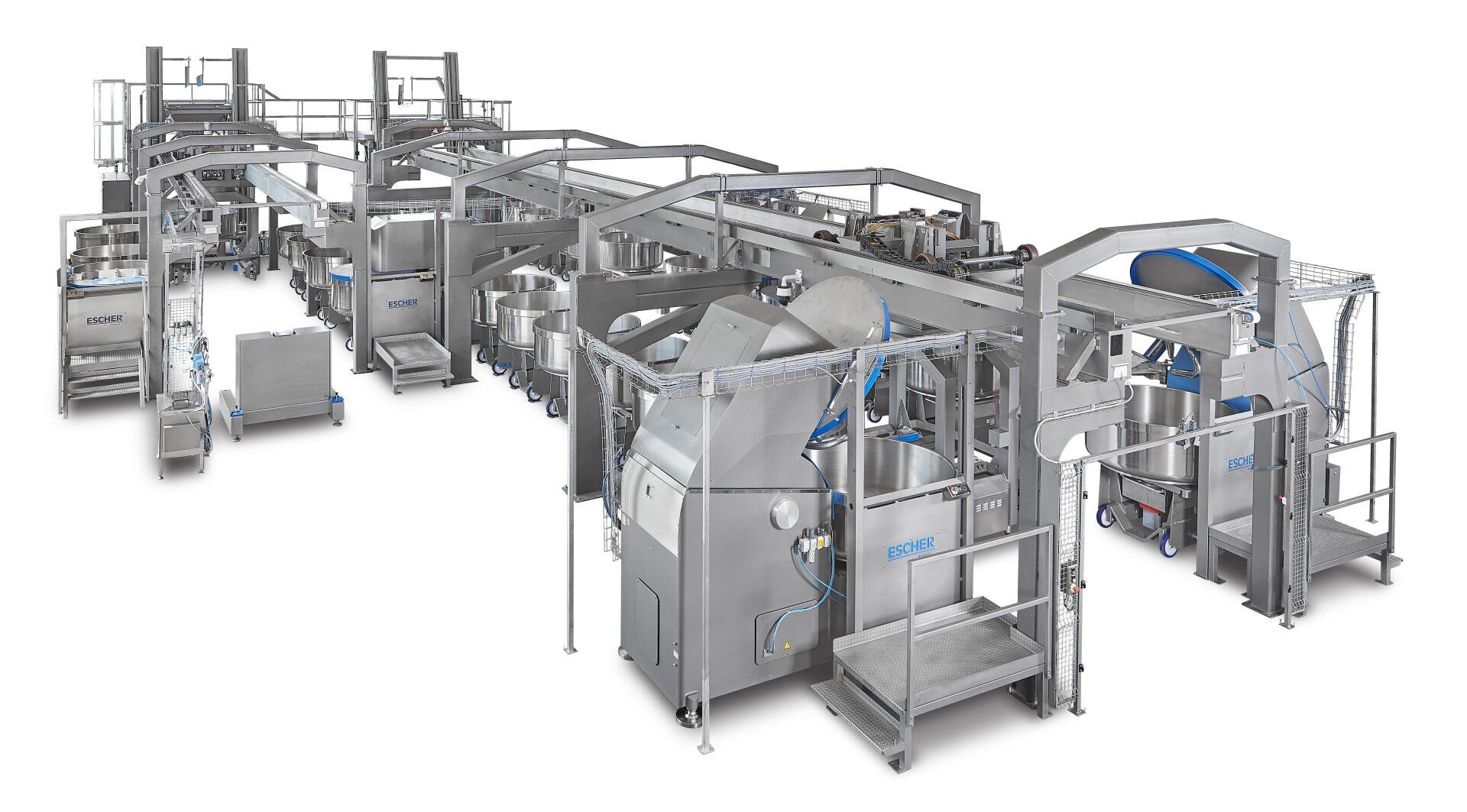 A large, industrial stainless steel food processing machine with multiple sections, platforms, stairs, and conveyor belts, designed for automated production in a factory setting.