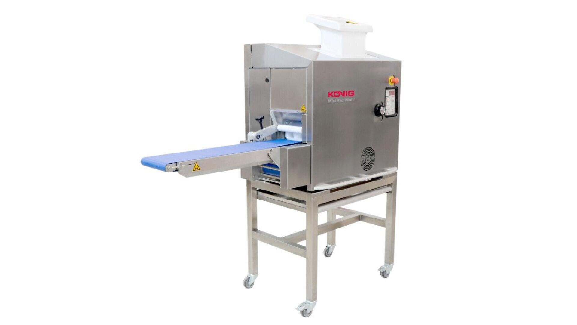 A stainless steel industrial machine with a blue conveyor belt, control panel, and wheels for mobility, labeled KONIG, designed for automated food processing or dough handling.