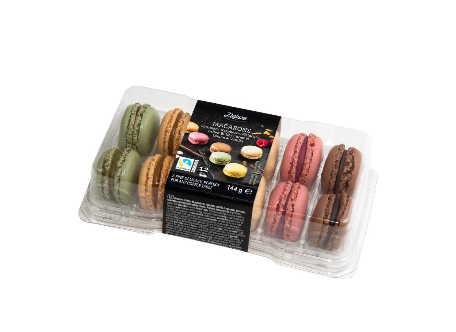 A clear plastic container holds 12 assorted macarons in green, brown, pink, and chocolate colors. The label displays the brand name, macaron images, and product information.