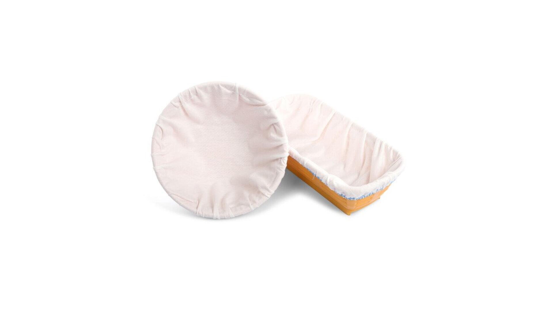 Two cloth-lined dough proofing baskets: one round, shown from the top, and one oval, shown from the side. Both baskets have light-colored fabric liners and wooden bases, set against a white background.