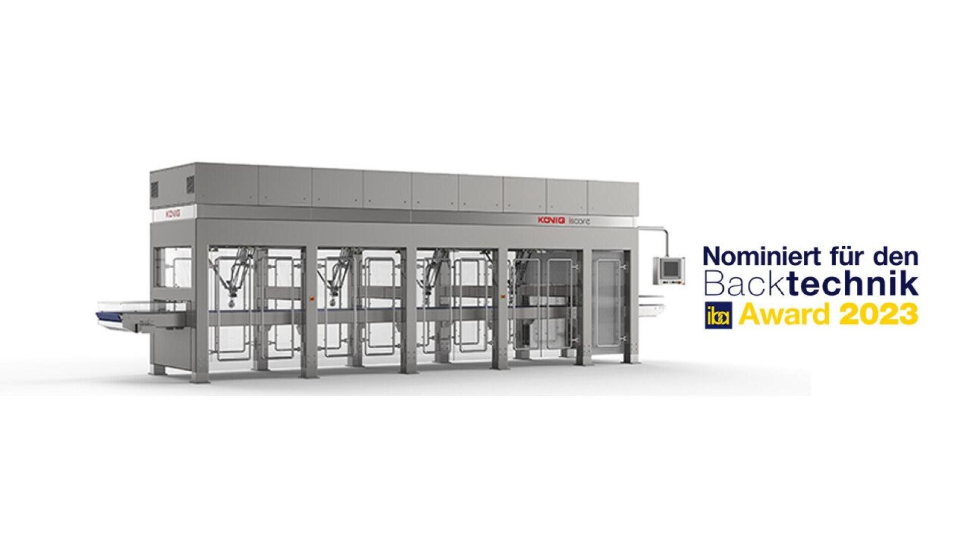 Large industrial bakery machine with a gray exterior, labeled König, next to text reading Nominiert für den Backtechnik IBA Award 2023 on a plain white background.