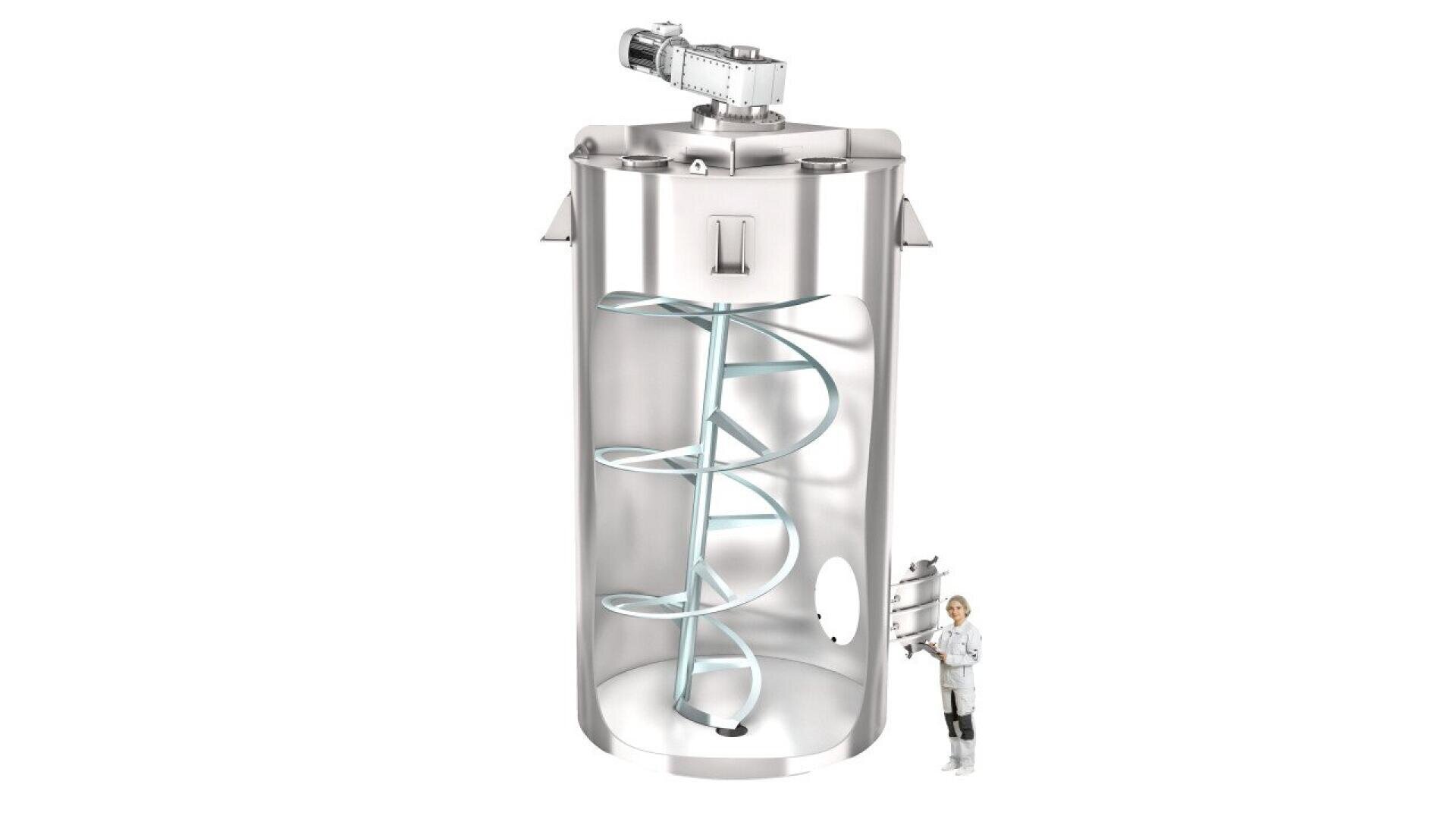 A scientist stands next to a large, cylindrical stainless steel mixing tank with an open side revealing a helical agitator inside and an electric motor mounted on top.