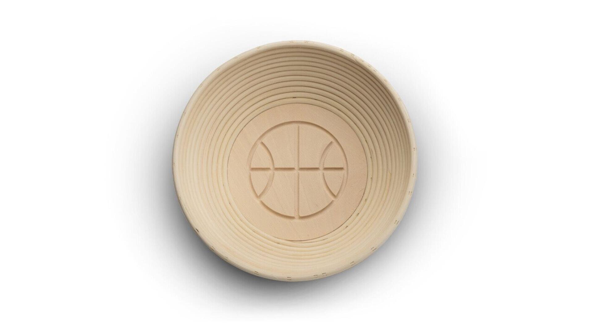 A round, light-colored, ribbed bowl with a design resembling a basketball embossed at the bottom, viewed from above on a white background.