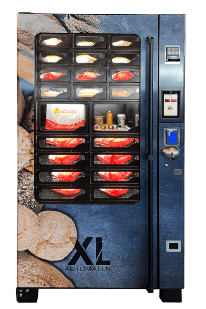 Ein Automat mit blauer Brot-Optik präsentiert hinter Glastüren Sandwiches und Snacks. Zahlungsmöglichkeiten, Knöpfe und ein Produktausgabeschlitz befinden sich auf der rechten Seite des Automaten.
