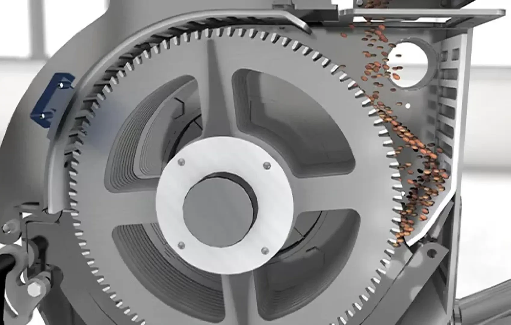 Nahaufnahme einer industriellen Schleifmaschine mit einem großen Metallzahnrad und braunen Pellets, die hindurchgeführt werden, um den mechanischen Prozess im Inneren des Geräts zu veranschaulichen.