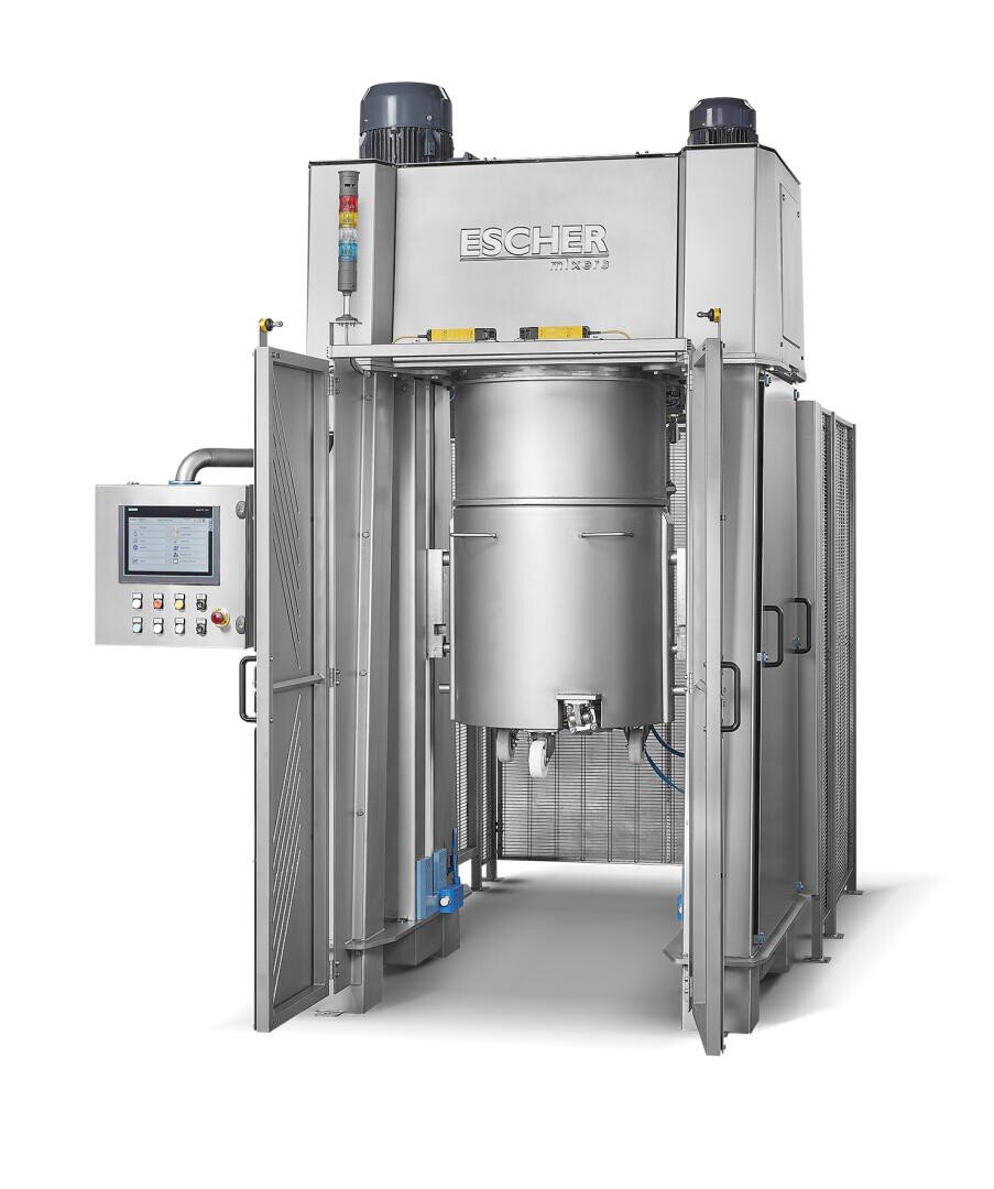 Large industrial stainless steel mixer with control panel and open doors, labeled ESCHER. The machine has a central mixing chamber, visible buttons, display screen, and two motors on top.