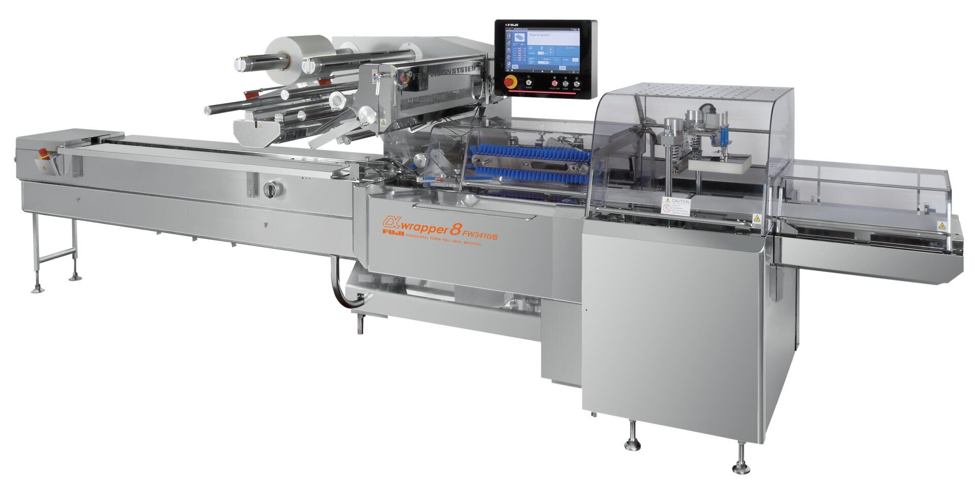 A large, stainless steel packaging machine with conveyor belts, rollers, a touchscreen control panel, and protective transparent covers for automated food or product wrapping.