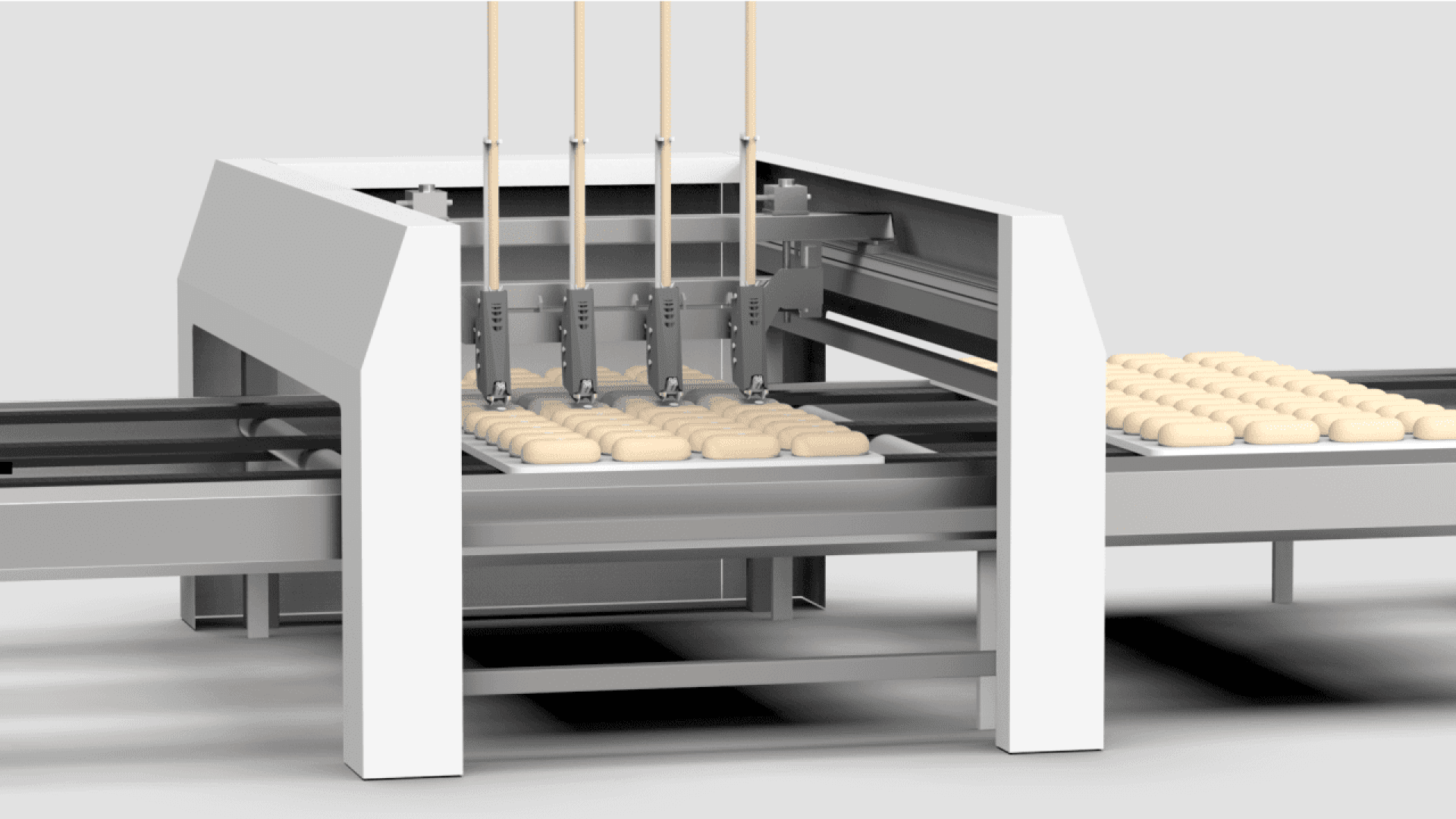 A modern industrial machine places rows of evenly spaced dough pieces onto a conveyor belt, likely as part of an automated bread or pastry production line.