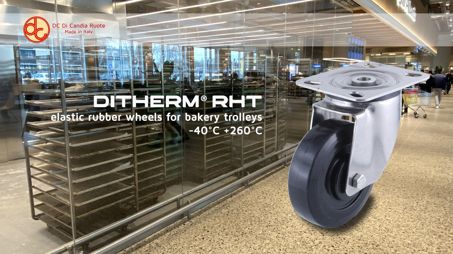 A large caster wheel is displayed in the foreground with text describing it as “DITHERM RHT elastic rubber wheels for bakery trolleys -40°C +260°C.” In the background is a bakery with empty racks and glass walls.