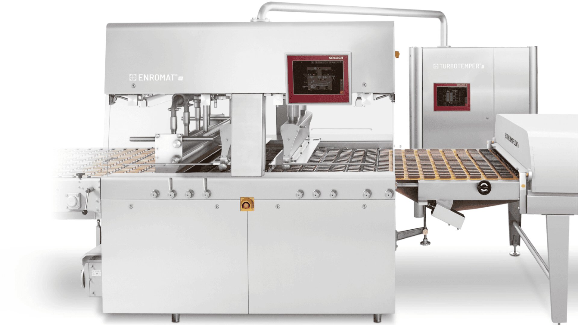 A large, stainless steel industrial enrobing machine with conveyor belts for coating products, digital control panels, and a modern, clean design, typically used in food processing or confectionery production.
