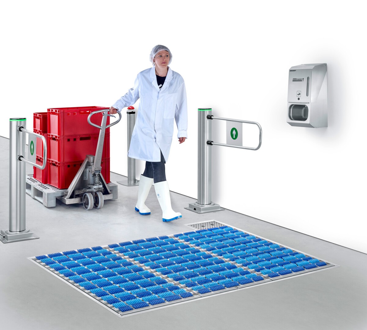 A worker in a white coat and hairnet pulls a cart with red containers through a sanitary entrance with a blue brush mat, automated gates, and a wall-mounted dispenser.