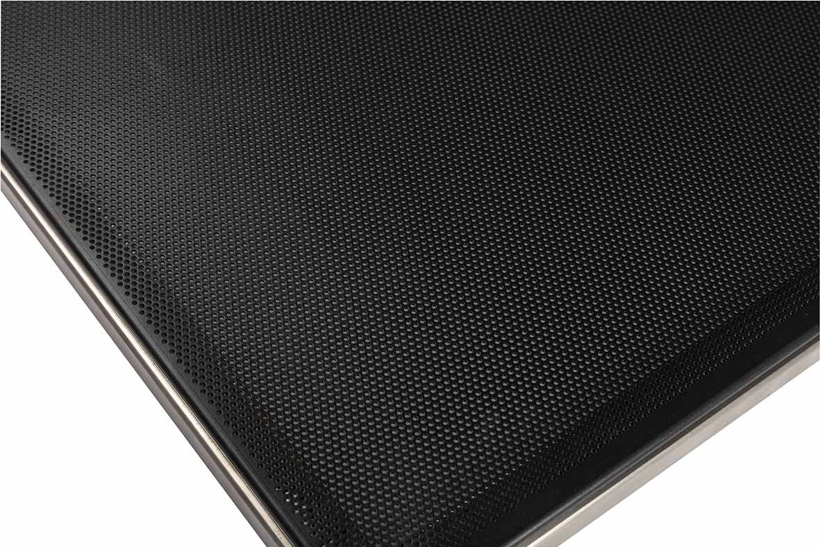 Close-up view of a black textured surface, possibly a speaker grill or a perforated metal panel, with a metallic edge visible along the sides.